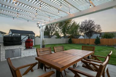 white house with white pergola and red BBQ grill in Boise, Idaho.