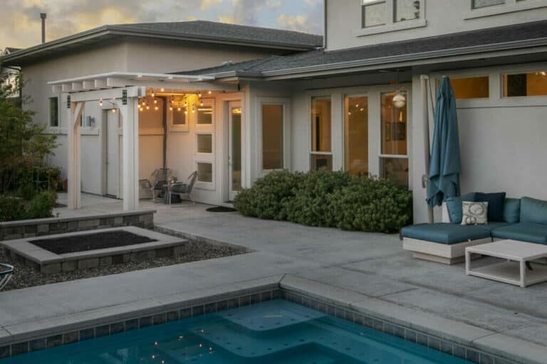 white house with white pergola and pool in Boise, Idaho.