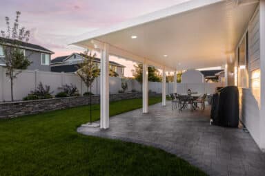 white house with a white patio cover and grey patio pavers in Boise, Idaho.