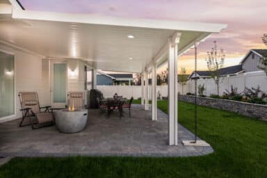 white house with a white patio cover and grey patio pavers in Boise, Idaho.
