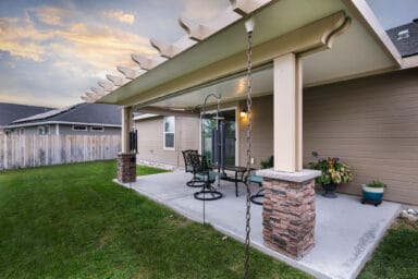 tan patio cover with black iron patio furniture in Boise, Idaho.