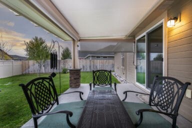 tan patio cover with black iron patio furniture in Boise, Idaho.