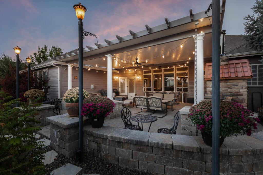 White and tan patio cover in Nampa, Idaho with a beautiful pink and purple sunset in the background.