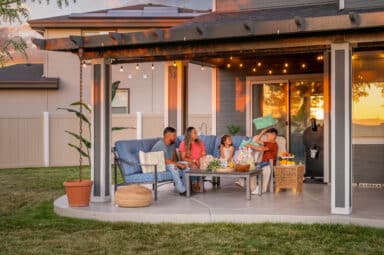 white and grey patio cover with scenery of a hispanic family enjoying their evening on the patio in Boise, Idaho.