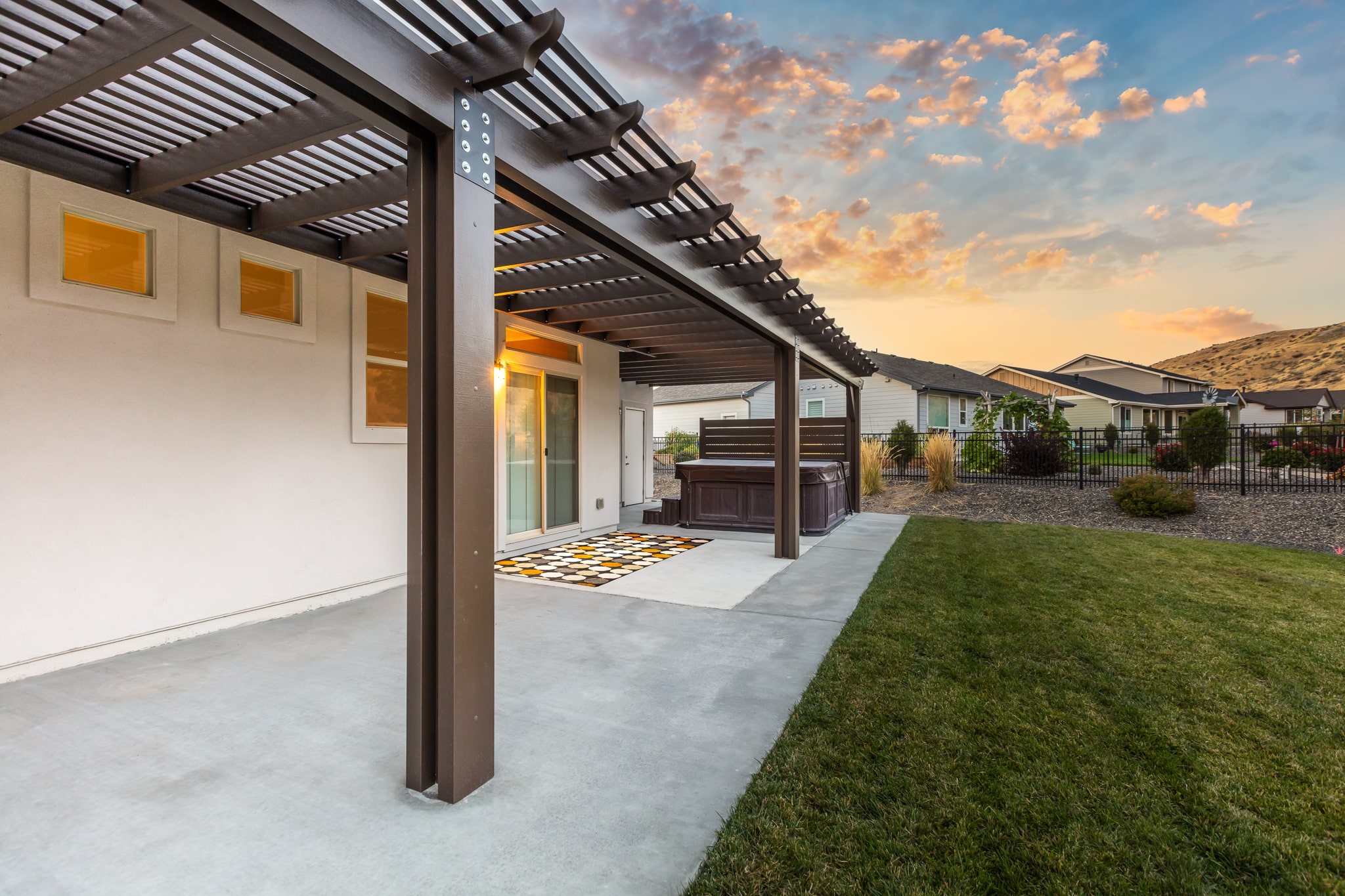 brown pergola connected to white house in Boise, Idaho.
