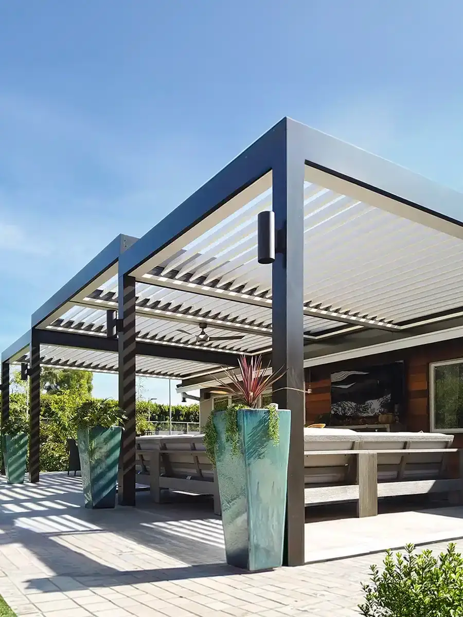 Adjustable louvered roof system allowing customizable sun, shade, and ventilation for outdoor living areas