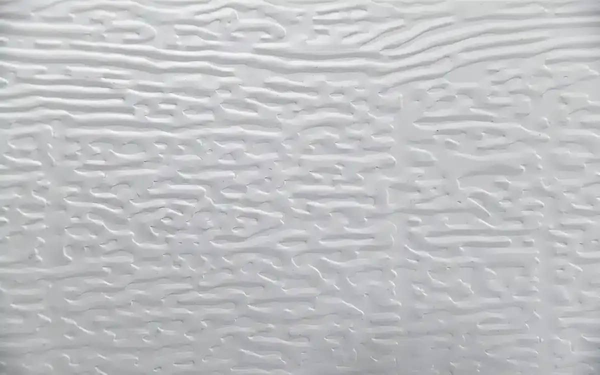 Close-up of embossed aluminum panel texture used in ShadeWorks patio cover systems