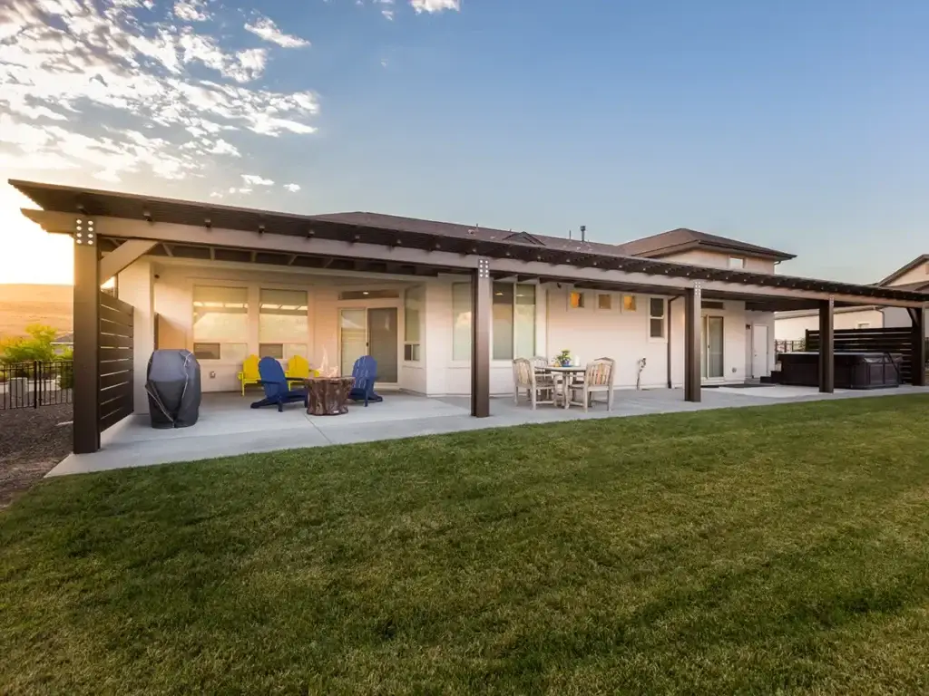 Attached patio cover creating reliable shade over a backyard seating area