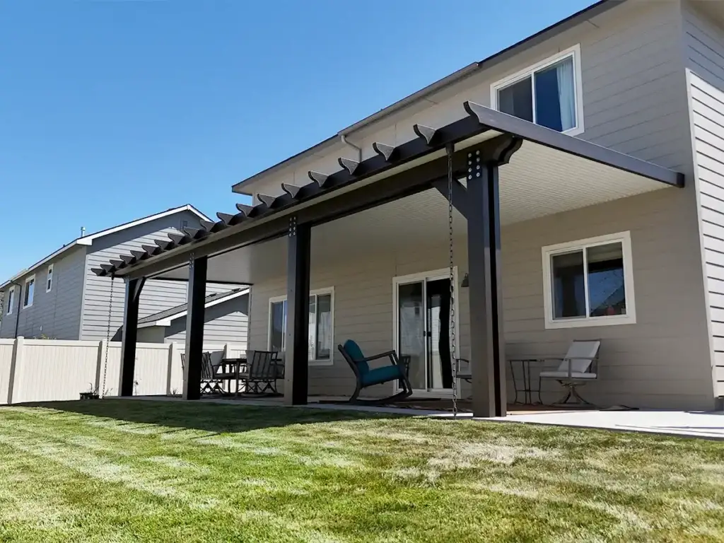 Modern aluminum patio cover attached to house creating shaded outdoor living space