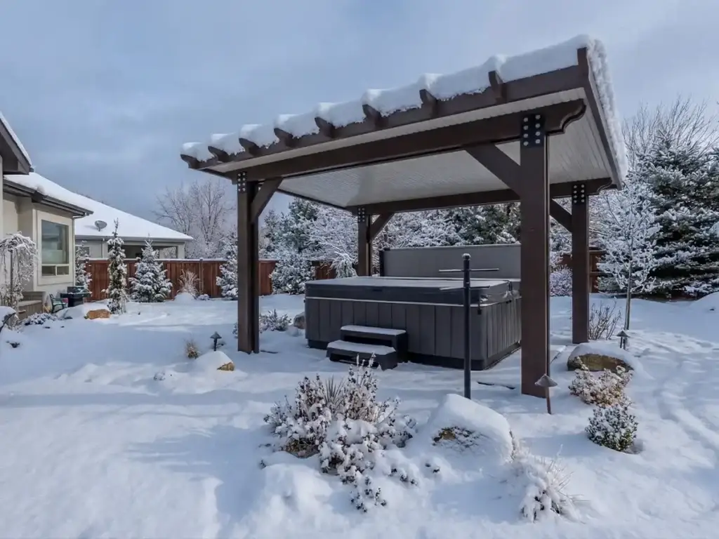 Patio cover in Eastern Idaho supporting snow load over a hot tub