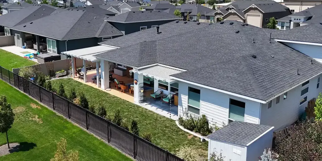 Backyard patio with overhead shade structure that makes the space more comfortable and usable
