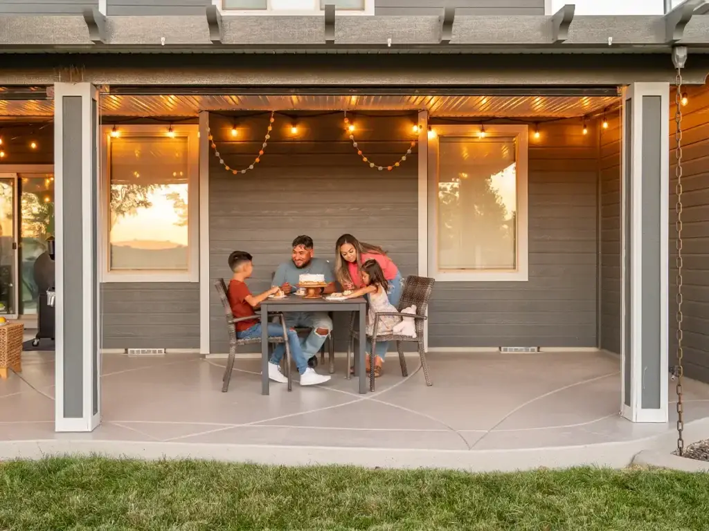 Family enjoying a shaded backyard patio during the daytime
