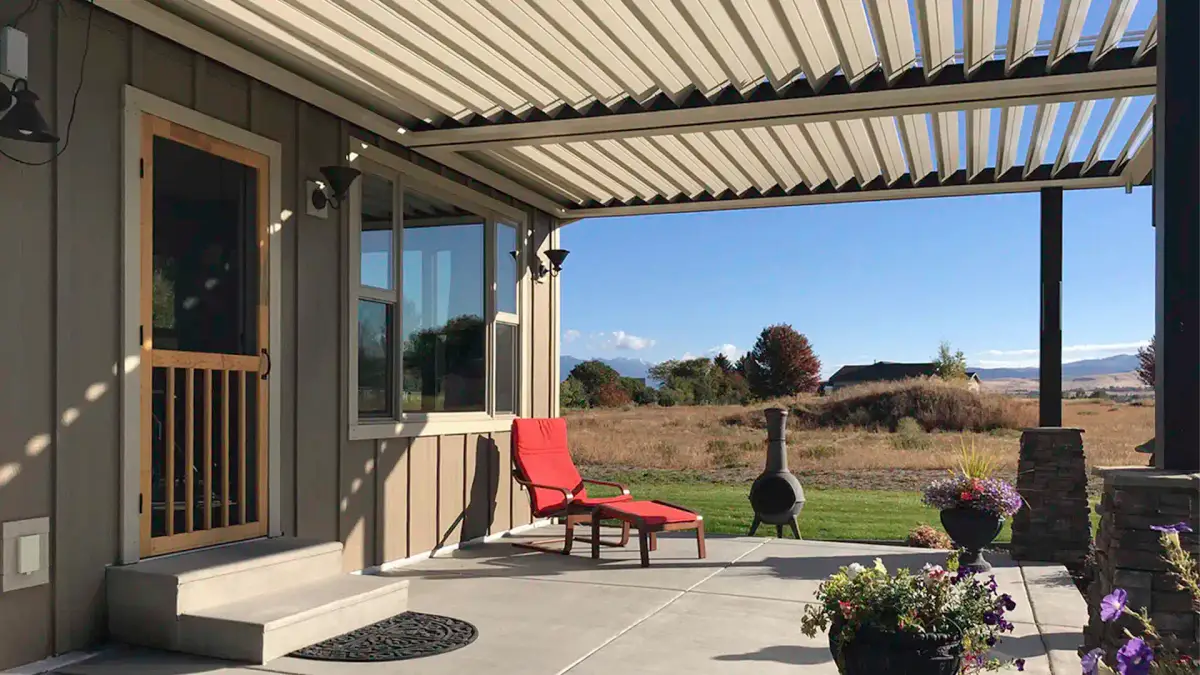 Louvered patio cover providing adjustable backyard shade and sun control