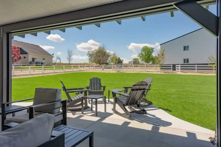Black insulated patio cover overlooking a spacious backyard