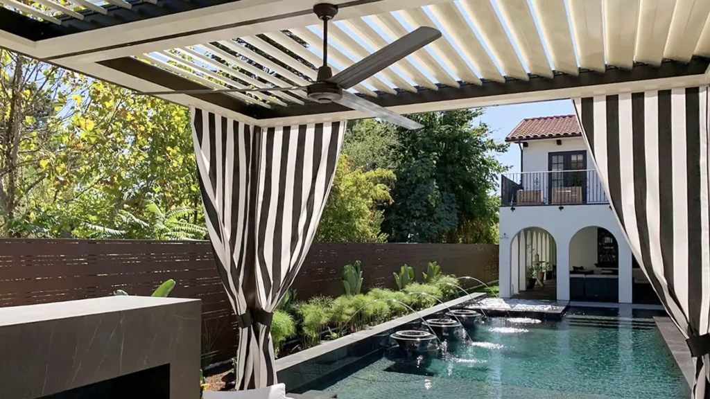 Motorized louvered roof system creating adjustable shade over a luxury poolside patio in Las Vegas.