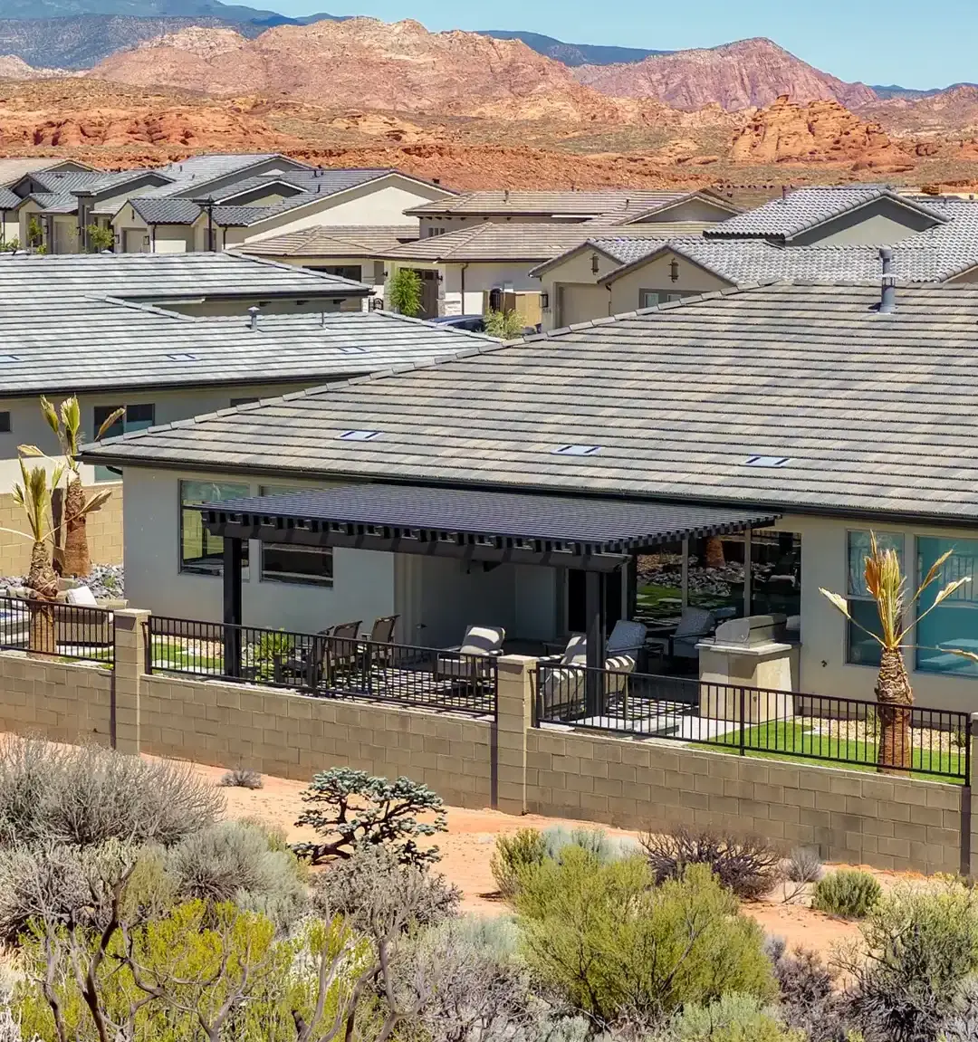 Custom attached pergola overlooking a Southern Utah backyard with red rock mountains in the background