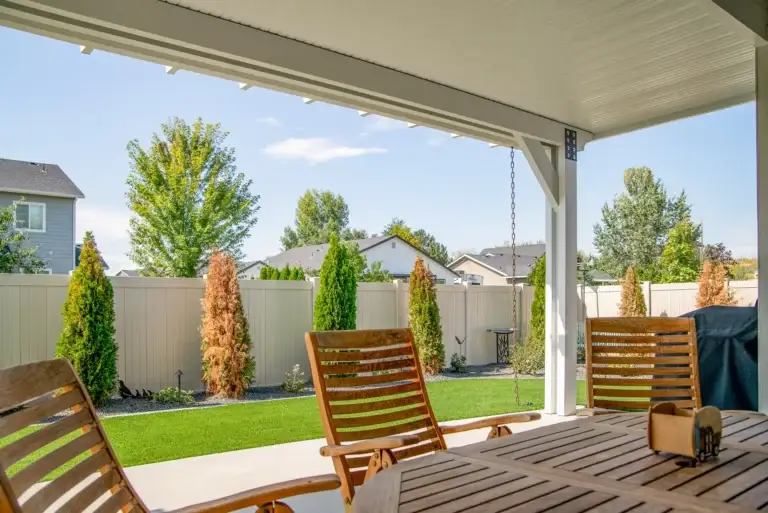 White insulated patio cover covering an outdoor dining area