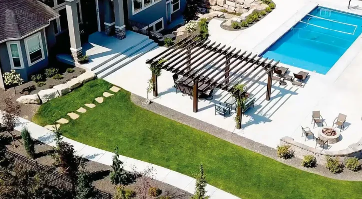 Aerial view of backyard patio cover and pergola installation beside residential swimming pool