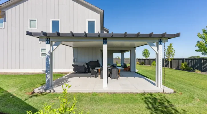 Custom attached patio cover with decorative pergola accents in a Boise backyard