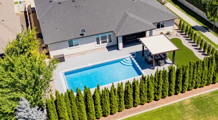 Boise backyard poolside pergola installed by ShadeWorks with aluminum shade structure overlooking a residential swimming pool