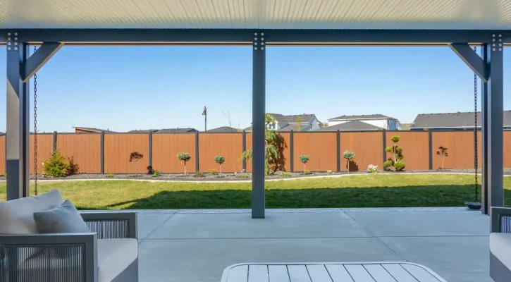 View of custom covered patio and insulated patio cover from backyard lawn
