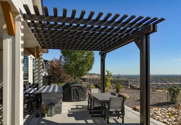 Custom aluminum pergola overlooking Boise Idaho backyard with outdoor dining area and hillside views