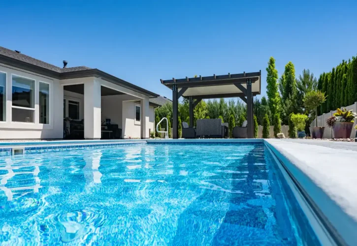 Freestanding insulated patio cover creating a poolside backyard retreat in Boise