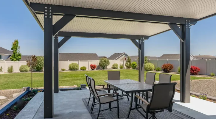Insulated aluminum patio cover covering an outdoor dining and entertainment space in Boise