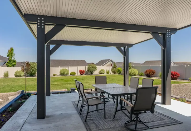 Insulated aluminum patio cover covering an outdoor dining and entertainment space in Boise