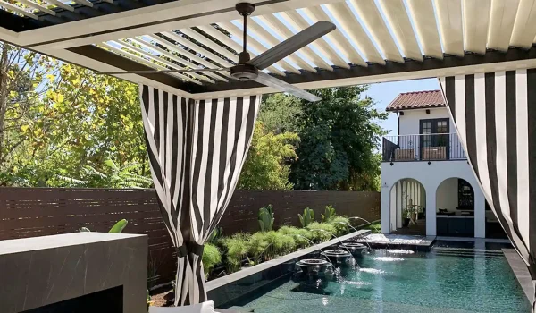 Motorized louvered roof system creating adjustable shade over a luxury poolside patio in Las Vegas.