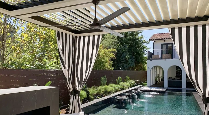 Motorized louvered roof system creating adjustable shade over a luxury poolside patio in Las Vegas.