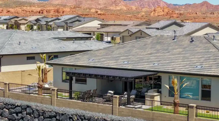 Custom aluminum louvered patio cover installed behind a Las Vegas home with Red Rock Canyon in the background.
