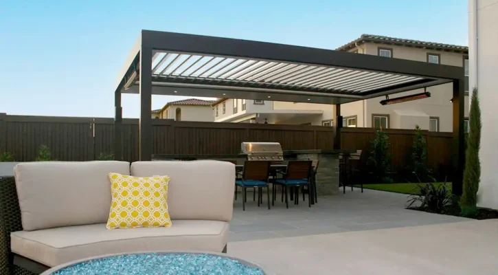 Louvered patio cover over backyard seating and dining area