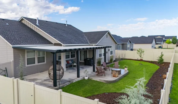 Custom aluminum patio cover installed over a backyard patio in Meridian, Idaho.