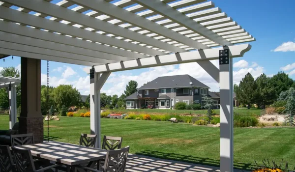 Custom white aluminum pergola covering an outdoor dining area in Meridian, Idaho.