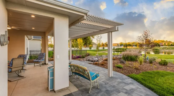 White aluminum pergola overlooking a waterfront backyard